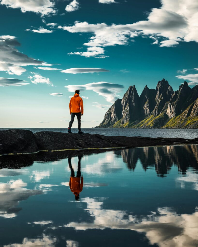 Explore stunning Senja with breathtaking views of the Devil's Teeth mountains and reflection.
